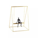 Escultura Metálica Dourada e Preta Mulher no Balanço